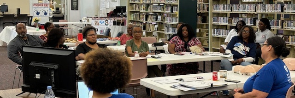 Group of adults sitting in the library during an event