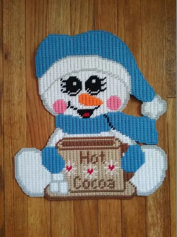 Holiday snowman made with plastic canvas will put a smile on your face this holiday season