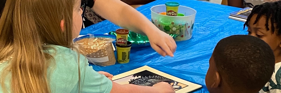 Four children at a table during an arts and crafts event