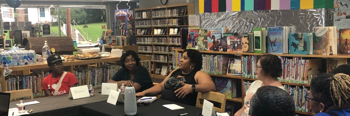 Group of adults during a discussion panel at the Evelyn Taylor Majure Library
